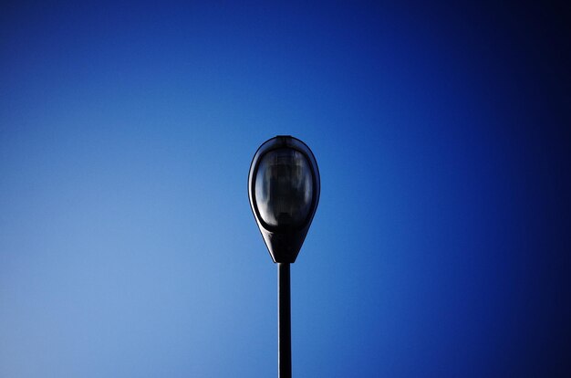 Low angle view of street light against clear blue sky