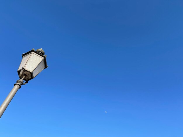 Low angle view of street light against clear blue sky