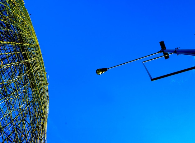 Low angle view of street light against clear blue sky