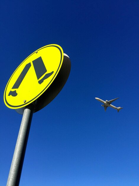 Low angle view of street light against clear blue sky