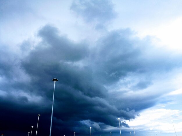 Low angle view of street light against cloudy sky