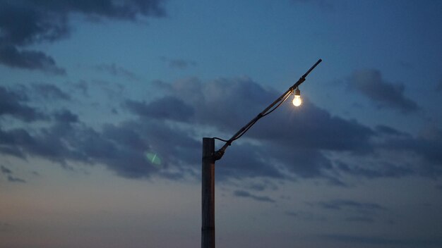 Low angle view of street light against sky at sunset