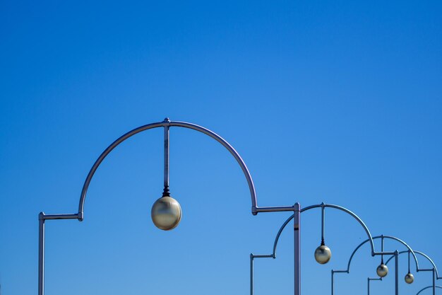 Low angle view of street lights against sky