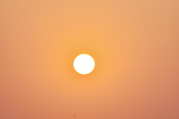 Low angle view of sun against orange sky