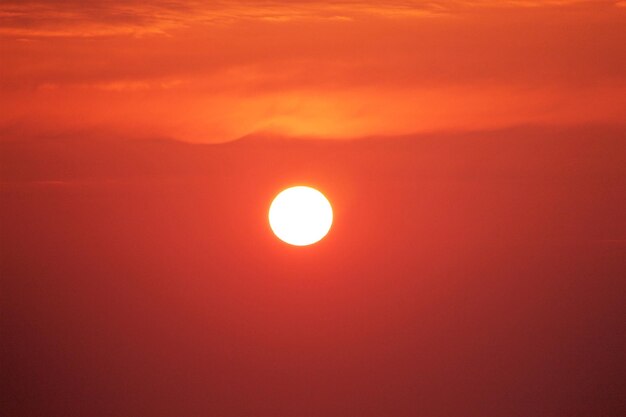 Low angle view of sun against orange sky