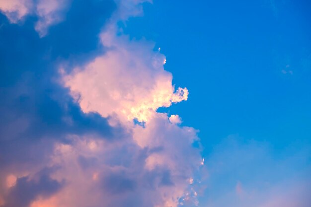 Low angle view of sunlight streaming through clouds