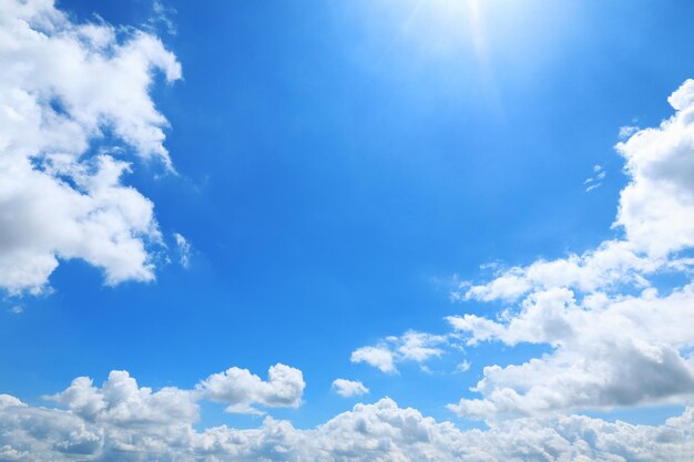 Low angle view of sunlight streaming through clouds