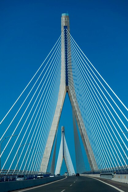 Low angle view of suspension bridge against blue sky