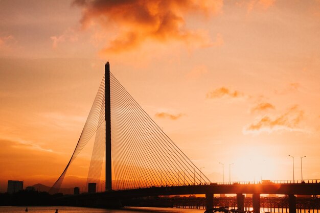 Low angle view of suspension bridge against sky during sunset