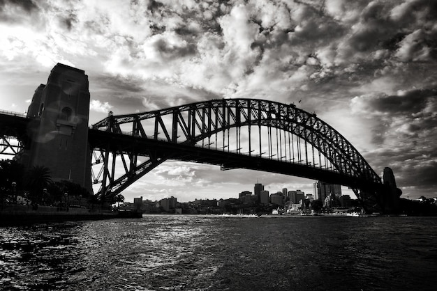 Low angle view of sydney harbor bridge against cloudy sky