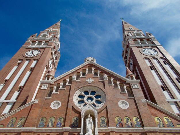 Low angle view of szeged cathedral against blue sky