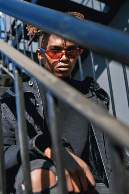 low angle view of teenage boy wearing sunglasses