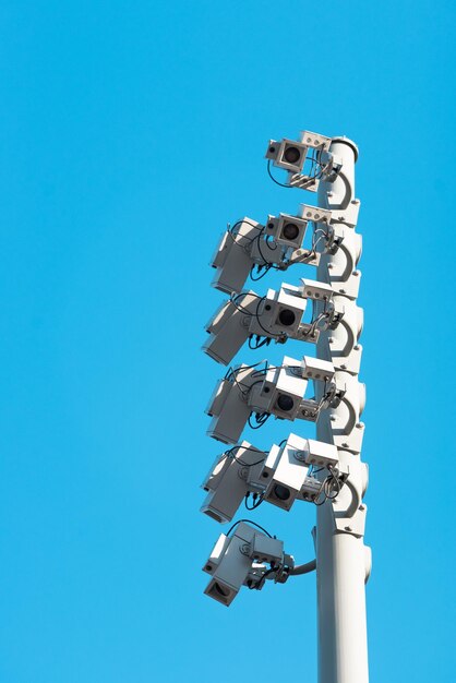 Low angle view of telephone pole against clear blue sky