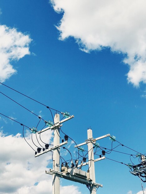 Low angle view of telephone pole against sky