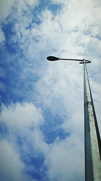 Low angle view of telephone pole against sky