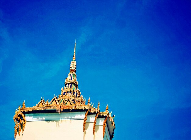 Low angle view of temple building against blue sky