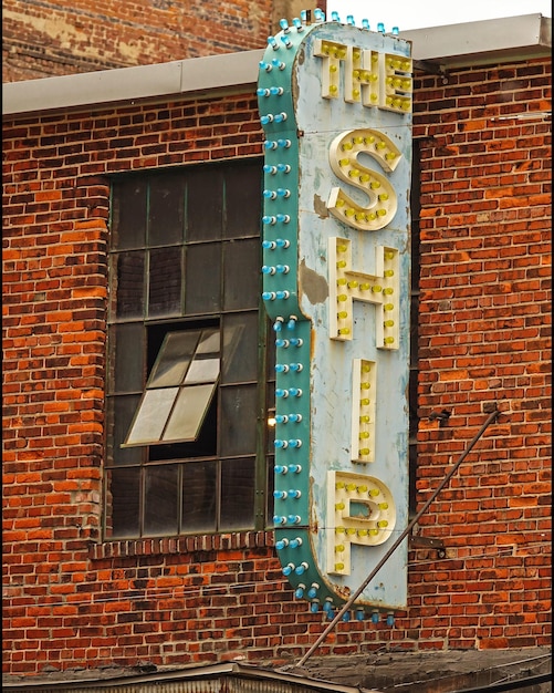 Photo low angle view of text on brick wall