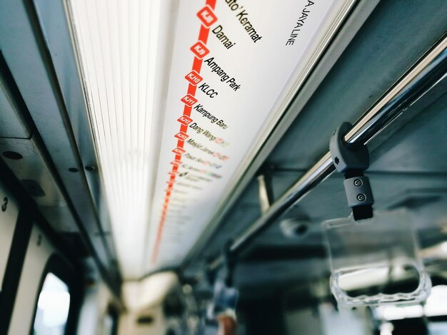 Photo low angle view of text on ceiling in train