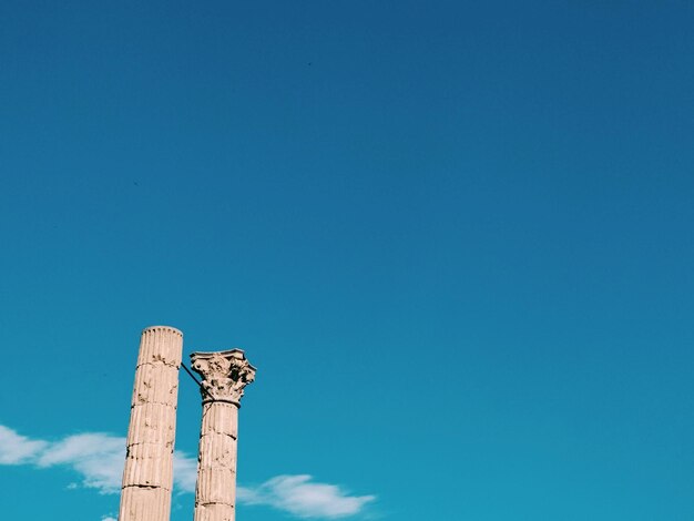 Low angle view of tower against blue sky