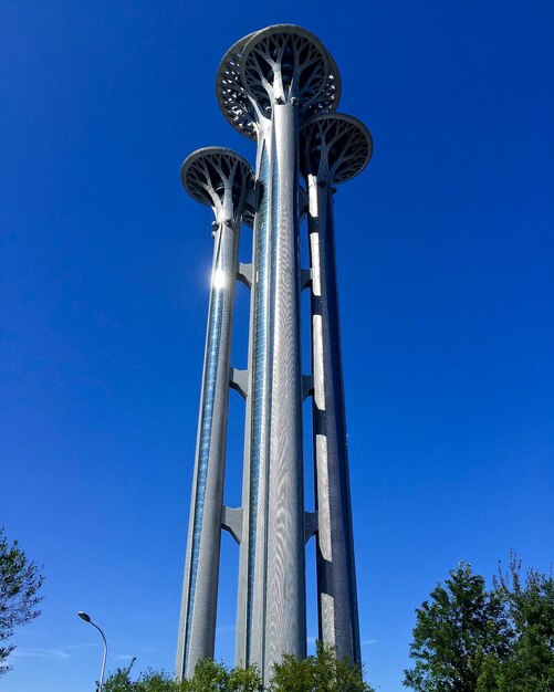 Low angle view of tower against blue sky