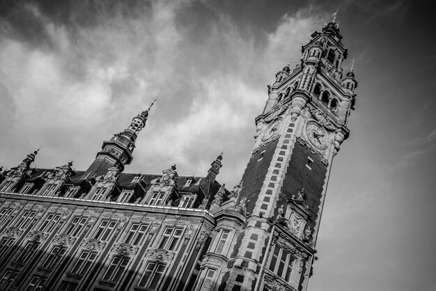 Low angle view of tower against cloudy sky