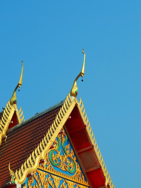 Low angle view of traditional building against clear blue sky