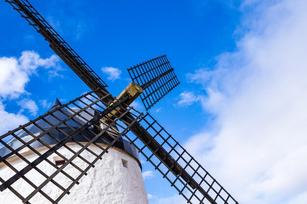 Low angle view of traditional windmill against blue sky