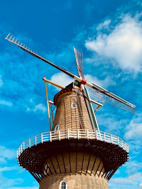 Low angle view of traditional windmill against sky