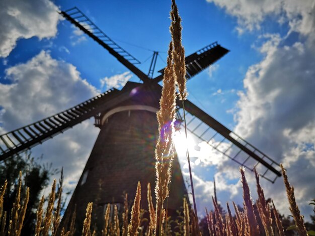 Low angle view of traditional windmill against sky