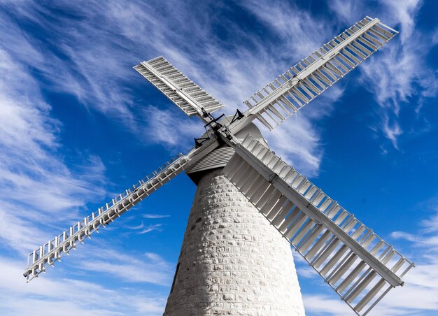 Low angle view of traditional windmill against sky