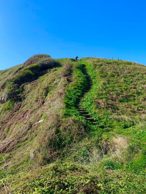 Low angle view of trail against clear blue sky