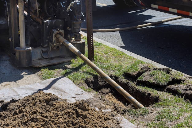 Low angle view of trenchless laying of communications, fiber optic and water pipes with horizontal directional drilling technology machine work process