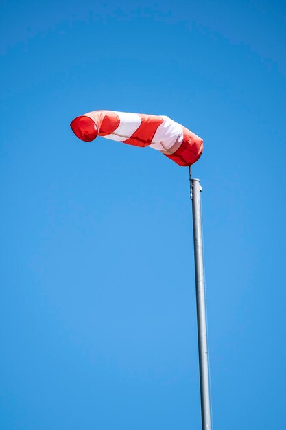 Low angle view of umbrella against clear blue sky