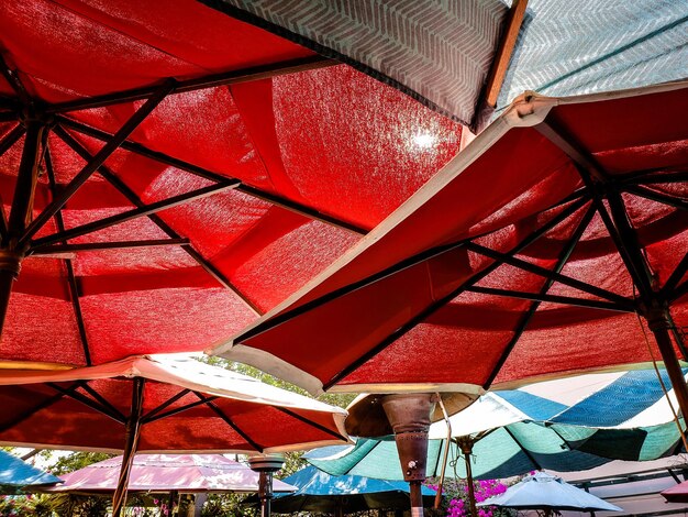 Low angle view of umbrellas on chair at restaurant