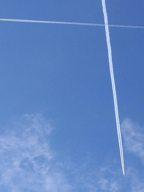 Low angle view of vapor trail against blue sky