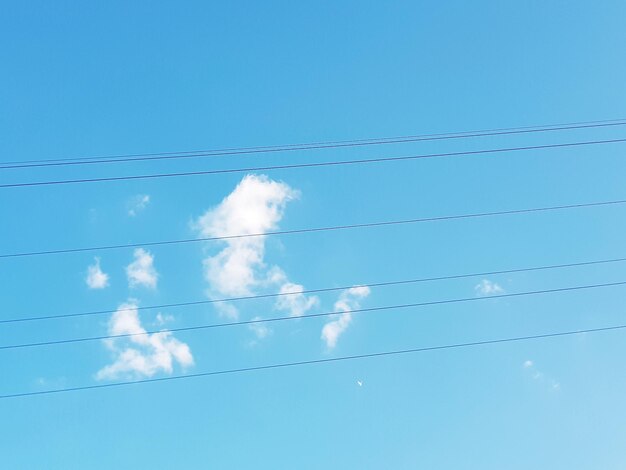 Low angle view of vapor trail against blue sky