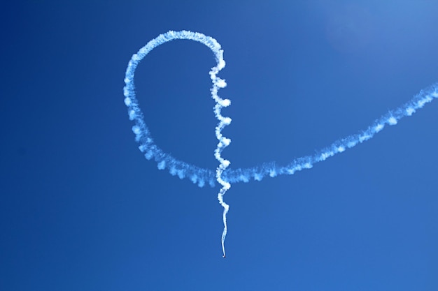 Low angle view of vapor trail against blue sky