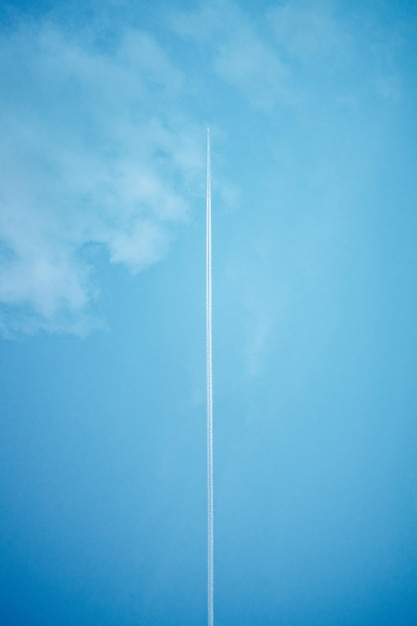 Low angle view of vapor trail against blue sky