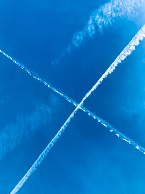 Low angle view of vapor trail against blue sky