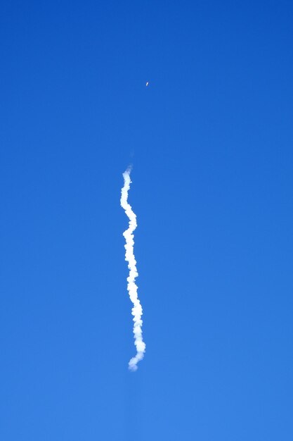 Low angle view of vapor trail against blue sky