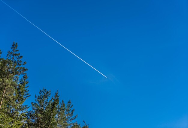 Low angle view of vapor trail against clear blue sky