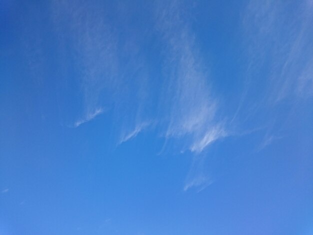 Low angle view of vapor trail in blue sky