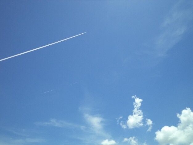 Low angle view of vapor trail in blue sky