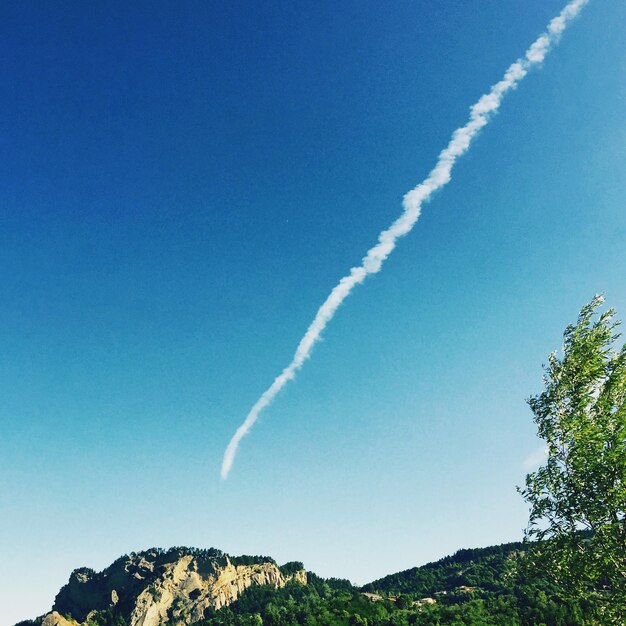 Low angle view of vapor trail in blue sky