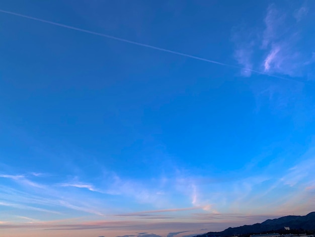 Low angle view of vapor trail in blue sky