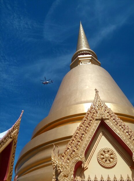 Low angle view of wat saket against blue sky