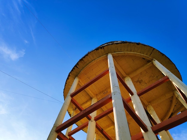 Low angle view of water tank against blue sky