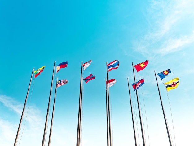 Low Angle View of Waving Flags of ASEAN Countries Against Blue Sky