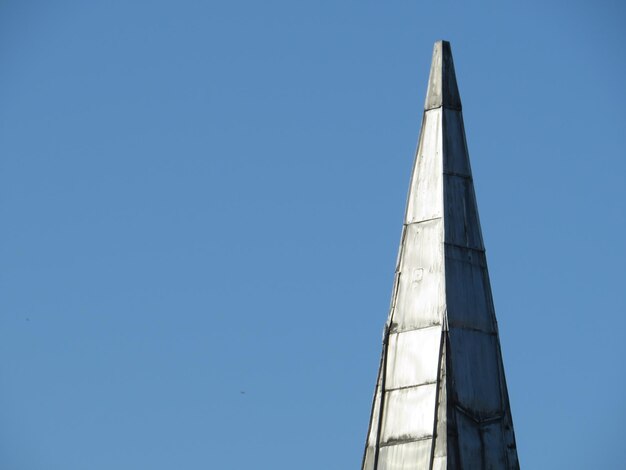 Low angle view of white building against clear blue sky