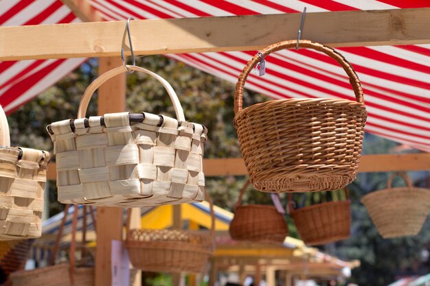 Photo low angle view of wicker baskets hanging at market stall